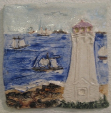 Louisbourg Lighthouse Wallhanging, with old lighthouse foundation in foreground, tall ships and the fortress in the background. 5.5 inches.